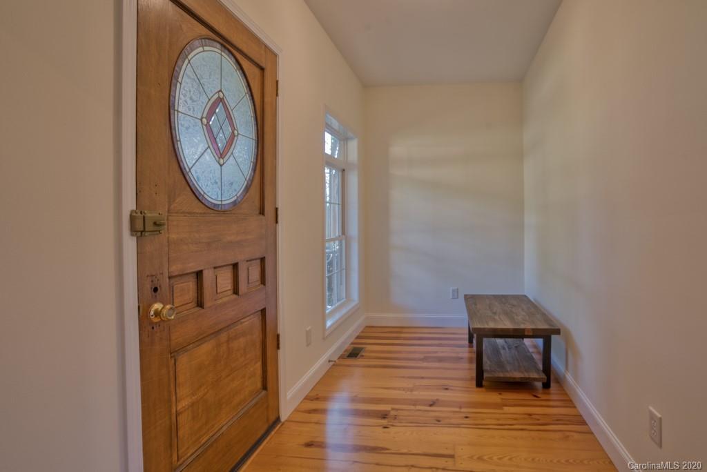 475 Gilbert Road Columbus, NC 28722 - Photo 14 of 45 a view of a hallway with wooden floor