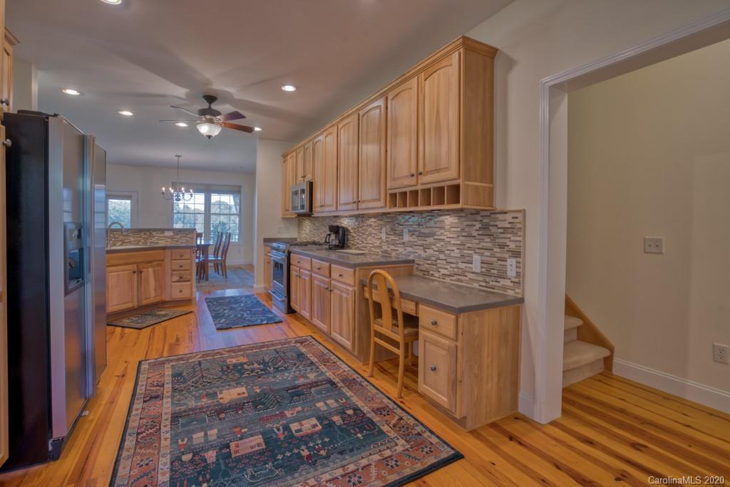 475 Gilbert Road Columbus, NC 28722 - Photo 15 of 45 a kitchen with stainless steel appliances granite countertop a stove a sink and a refrigerator