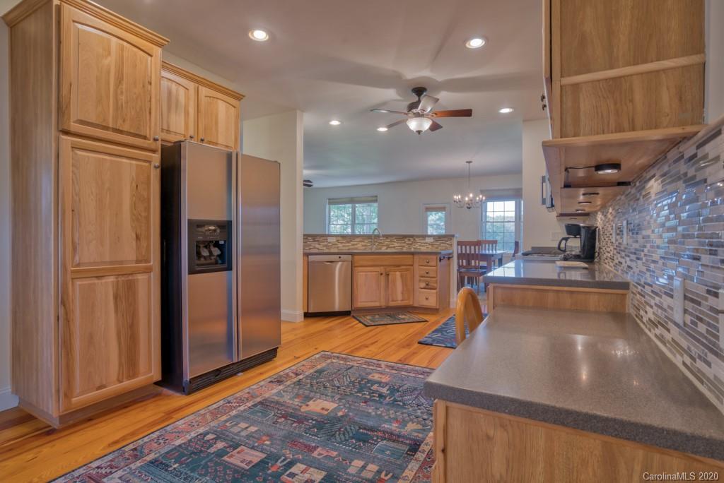 475 Gilbert Road Columbus, NC 28722 - Photo 16 of 45 a large kitchen with stainless steel appliances a refrigerator and a sink