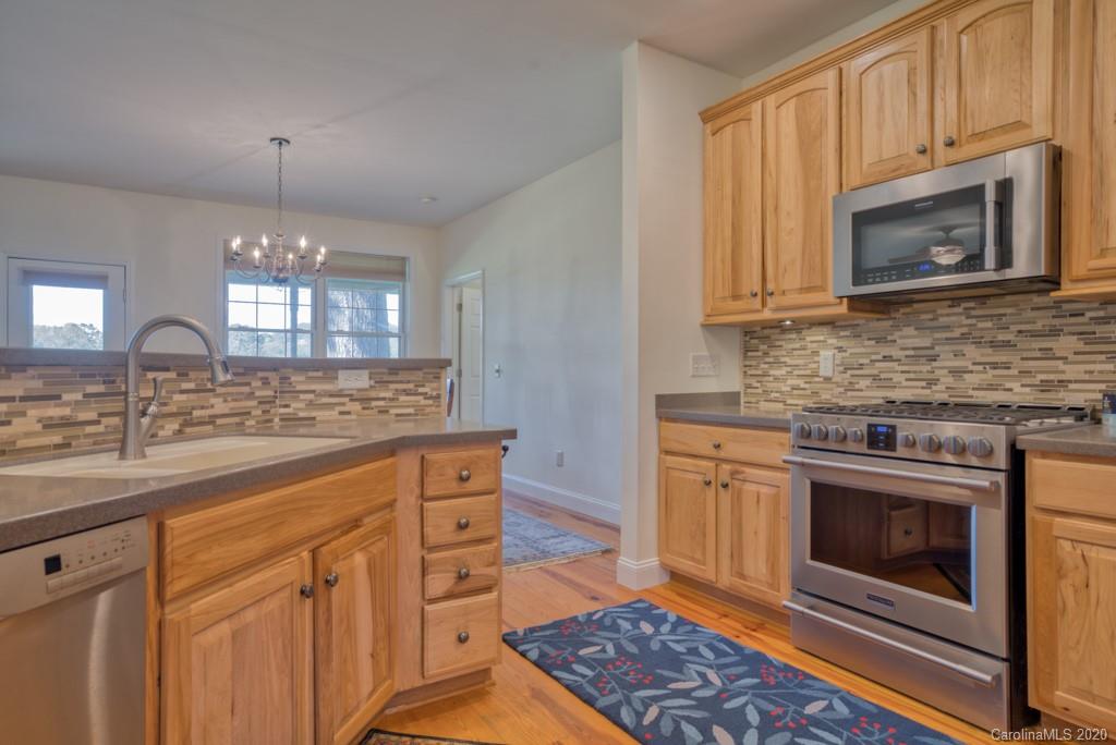 475 Gilbert Road Columbus, NC 28722 - Photo 17 of 45 a kitchen with stainless steel appliances granite countertop a stove microwave and sink