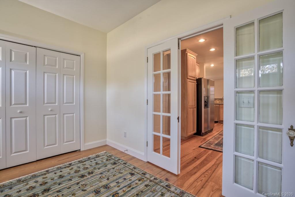 475 Gilbert Road Columbus, NC 28722 - Photo 24 of 45 a view of a hallway with wooden floor and cabinet