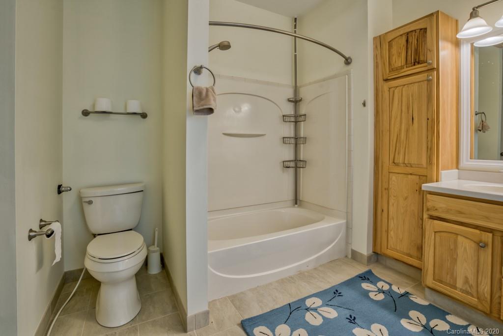 475 Gilbert Road Columbus, NC 28722 - Photo 25 of 45 a bathroom with a toilet and a shower