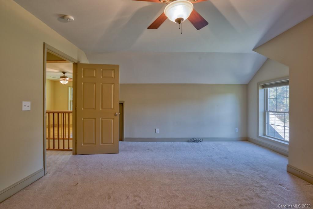 475 Gilbert Road Columbus, NC 28722 - Photo 30 of 45 en empty room with windows and fan