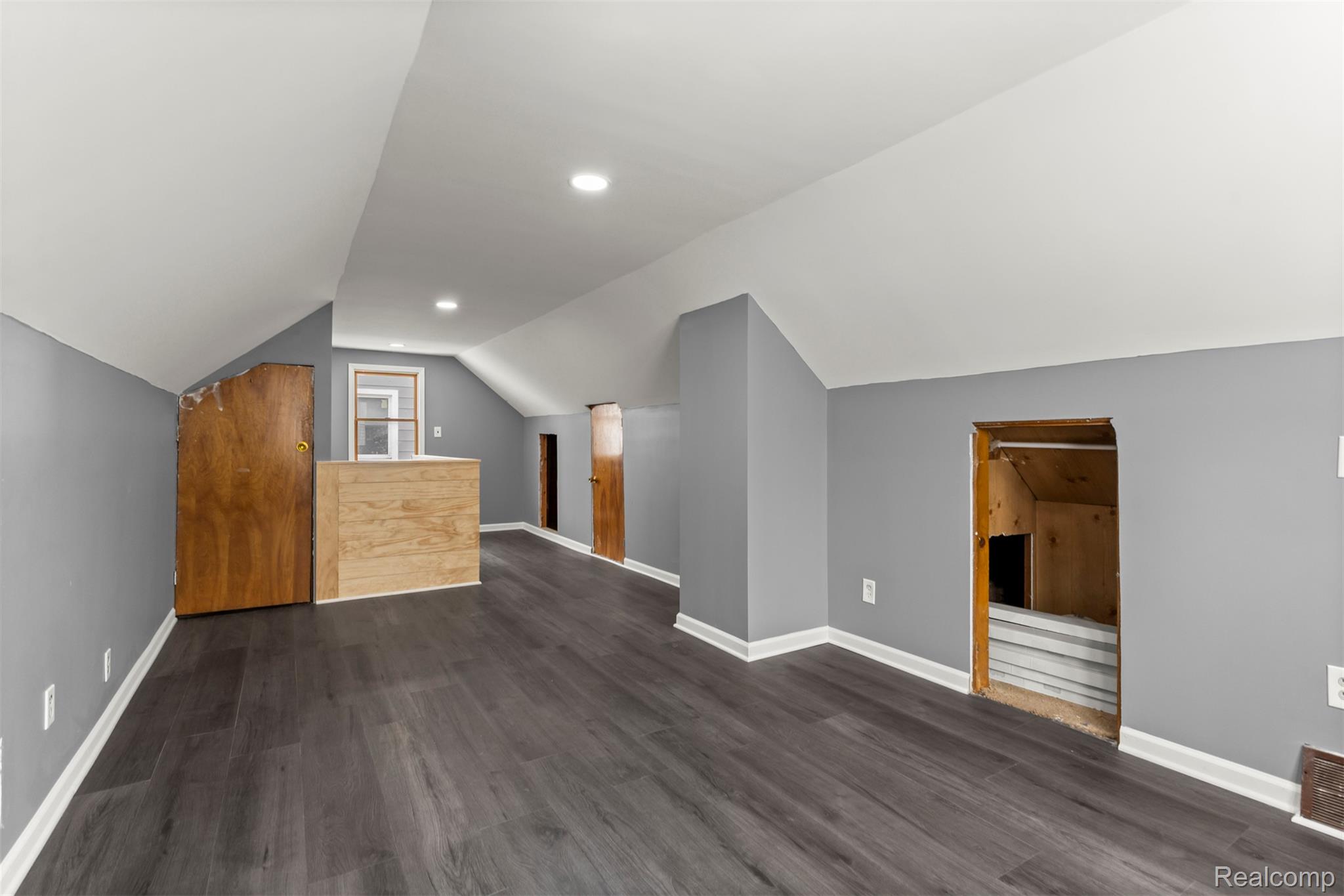 14716 Eureka Road Southgate, MI 48195 - Photo 28 of 42 Bonus room featuring lofted ceiling, dark wood-style floors, and recessed lighting