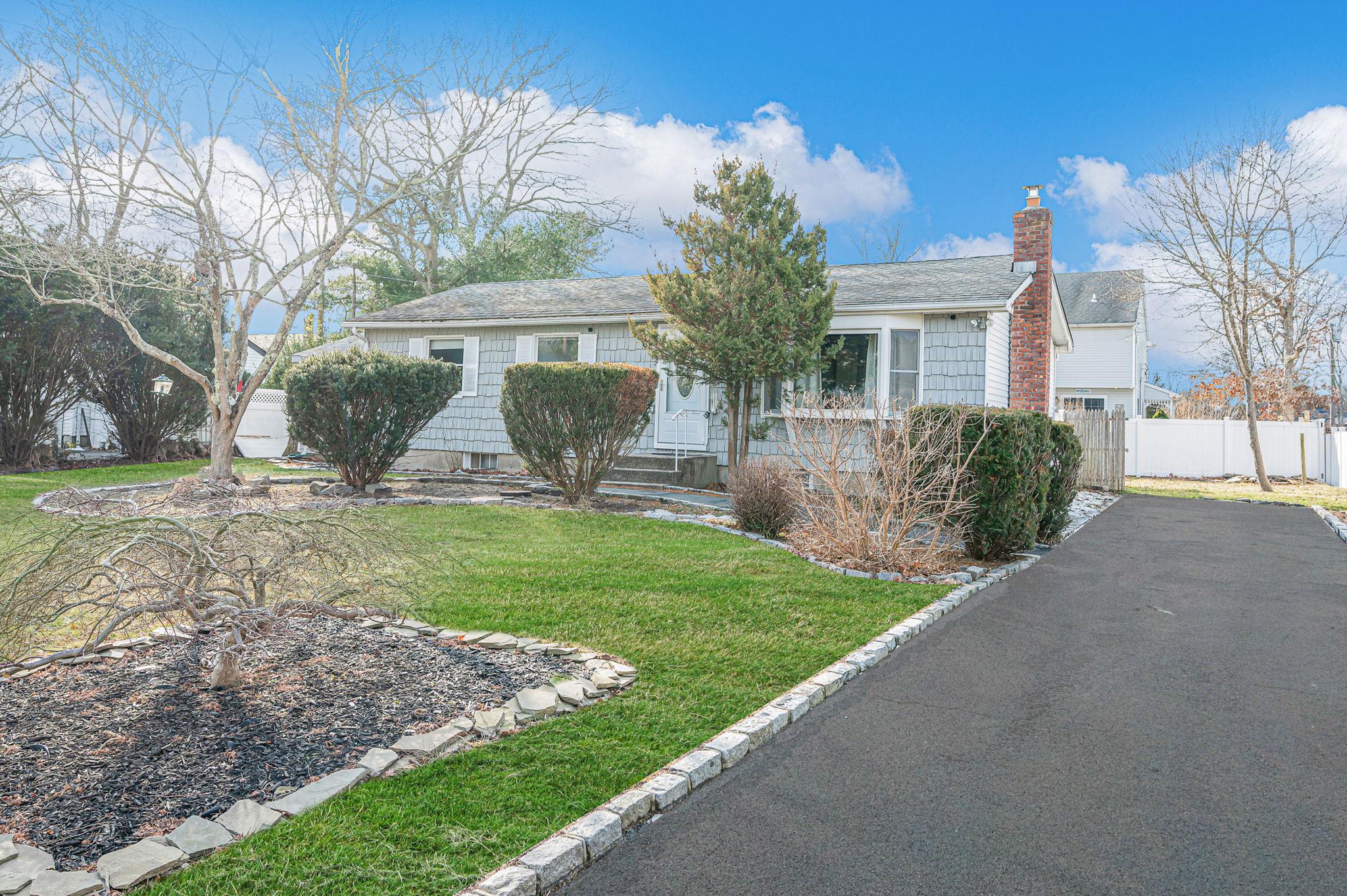 View of front of home featuring a garage and a front lawn
