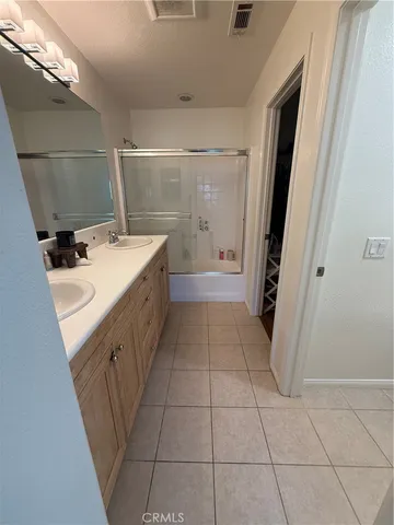 a bathroom with a sink a toilet and a shower