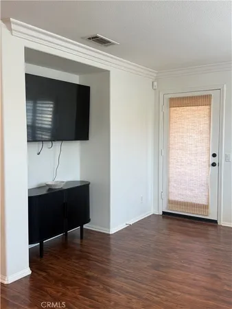 a view of workspace with wooden floor windows and cabinet