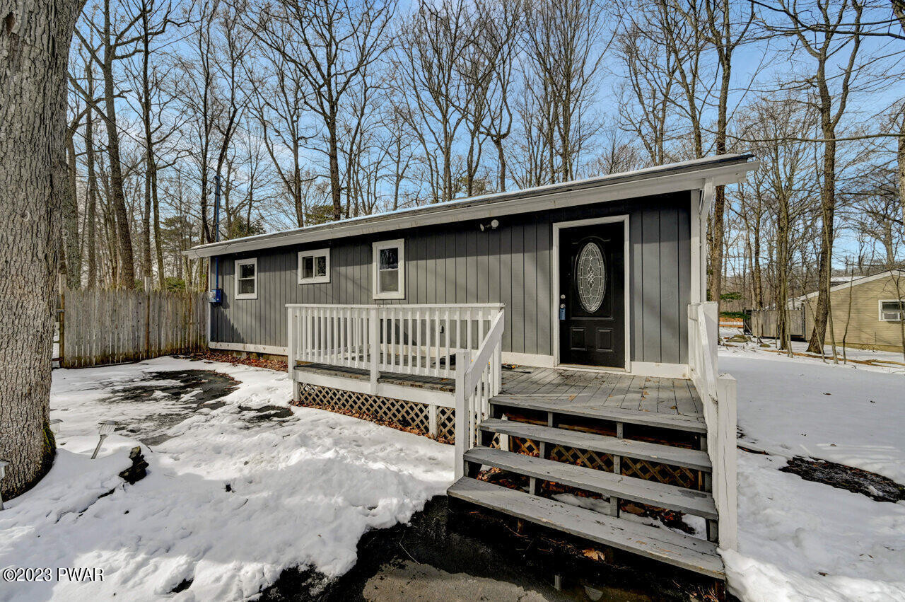 119 Hemlock Road Milford, PA 18337 - Photo 1 of 42 a view of a house with a bed and wooden fence