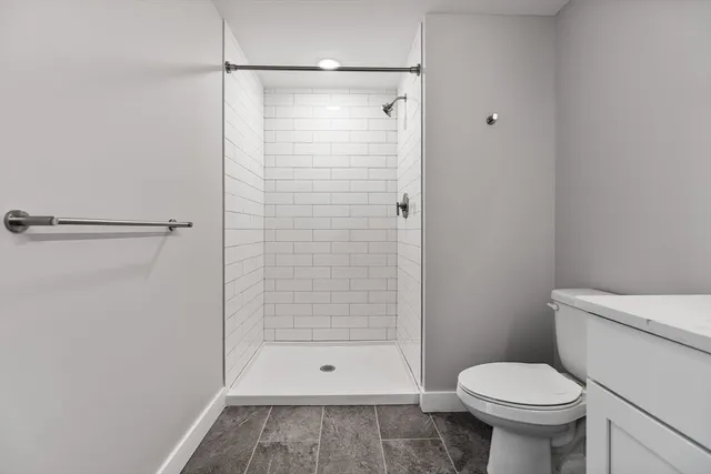 a bathroom with a shower and a toilet