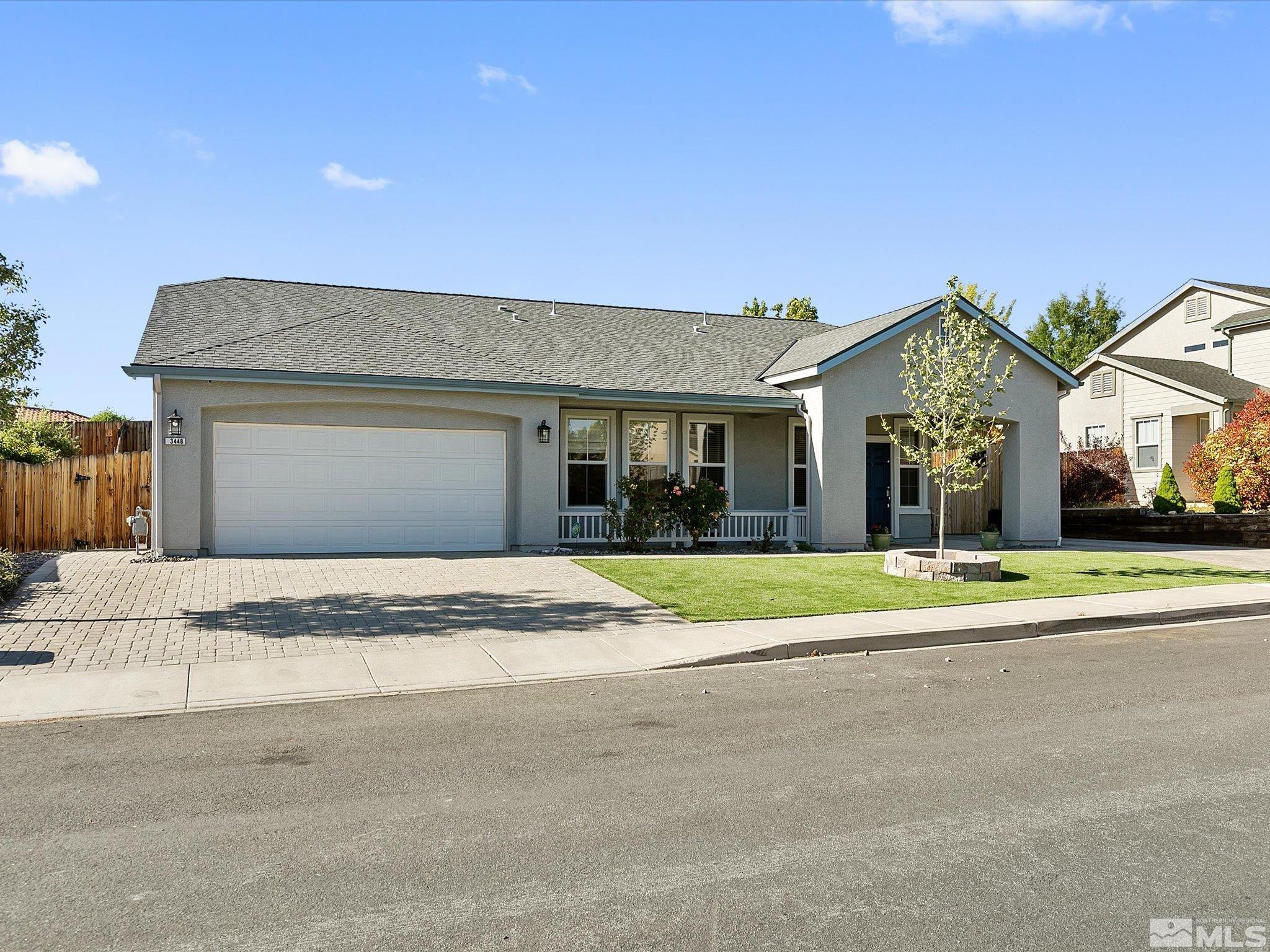 3448 Weaver Place Reno, NV 89512 - Photo 3 of 34 a front view of a house with a yard and garage