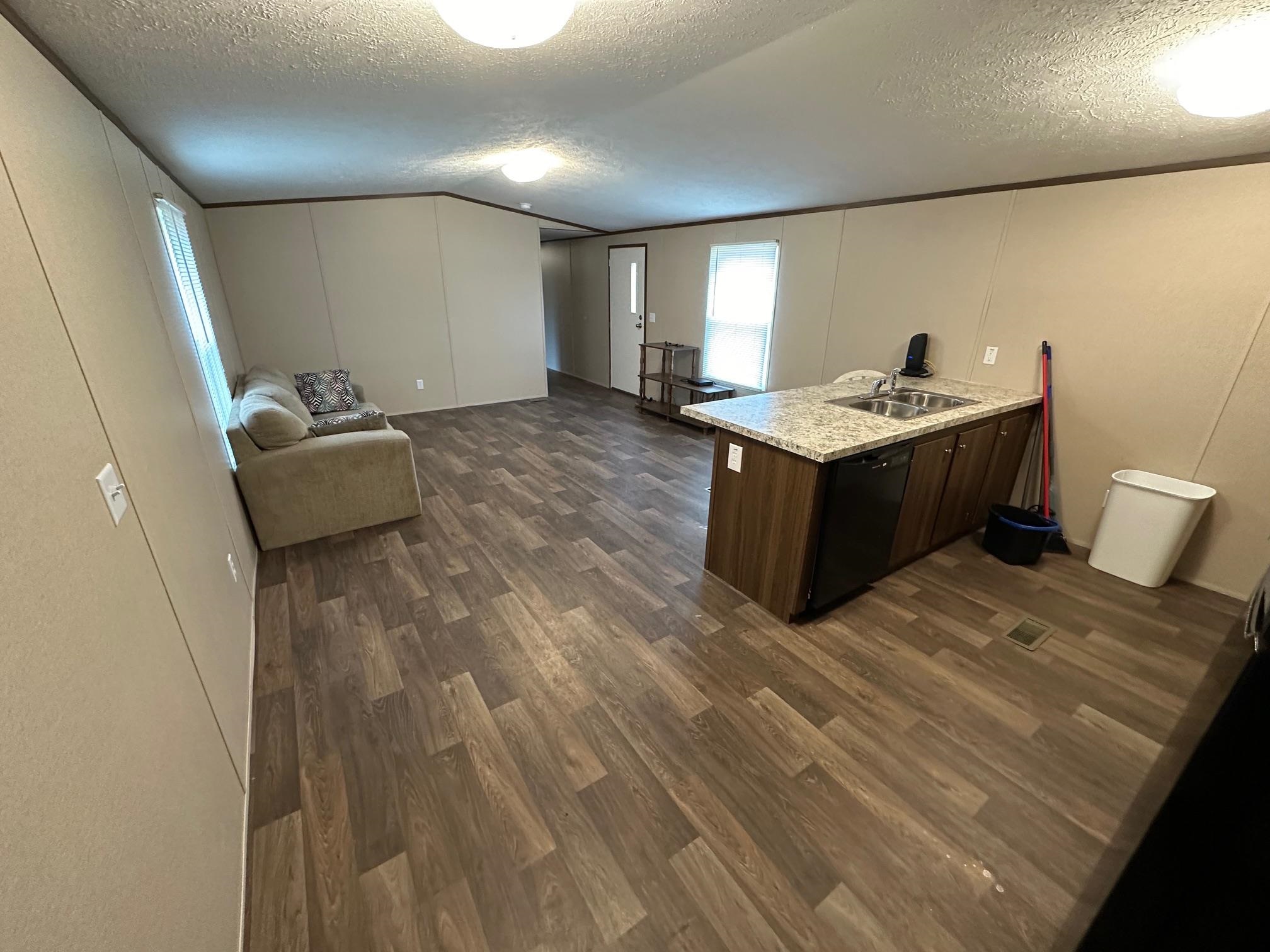 1696 Hardin Graveyard Road Adamsville, TN 38310 - Photo 15 of 25 a room with a couch and a wooden floor