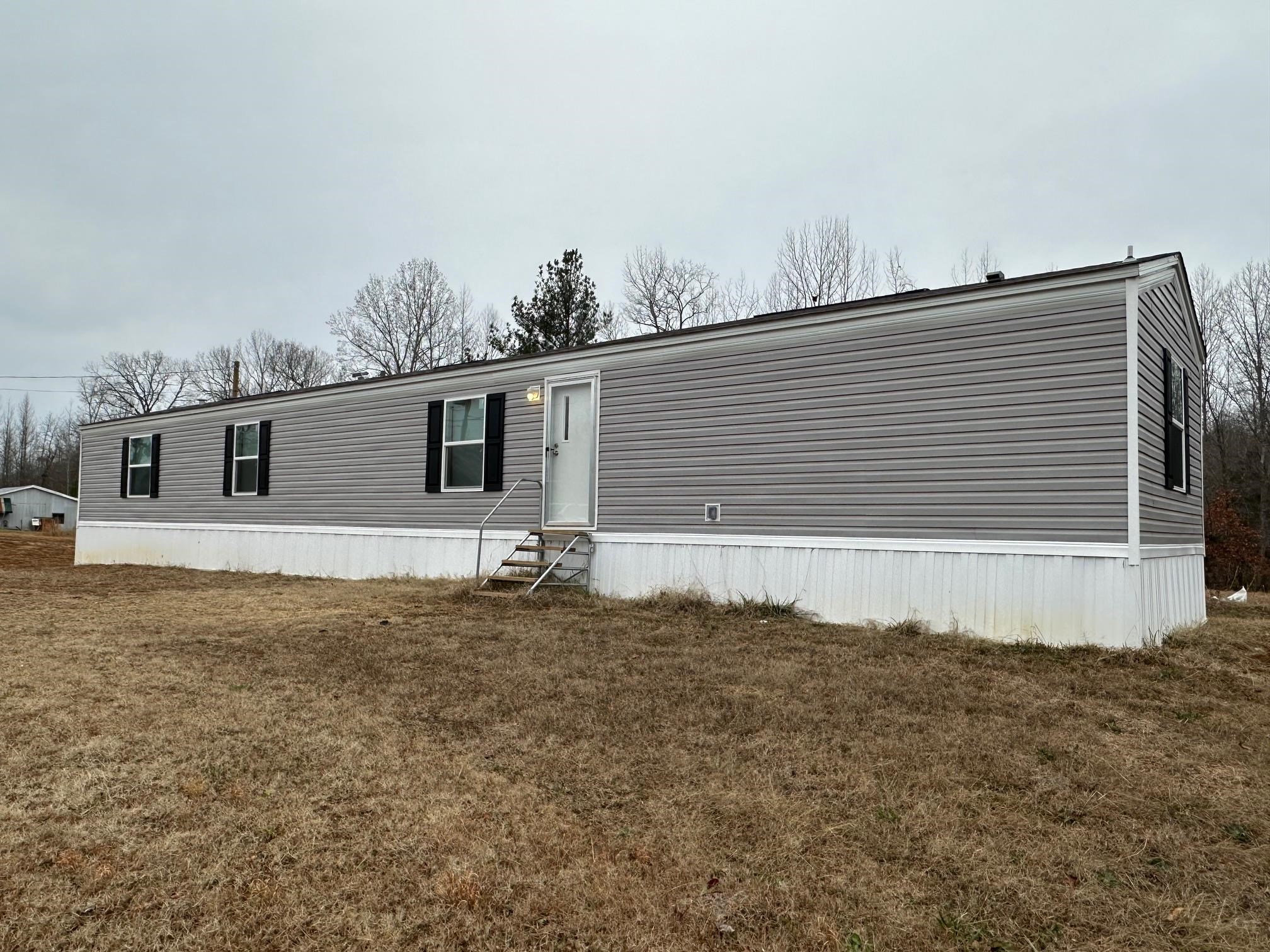1696 Hardin Graveyard Road Adamsville, TN 38310 - Photo 17 of 25 a view of a house with a backyard