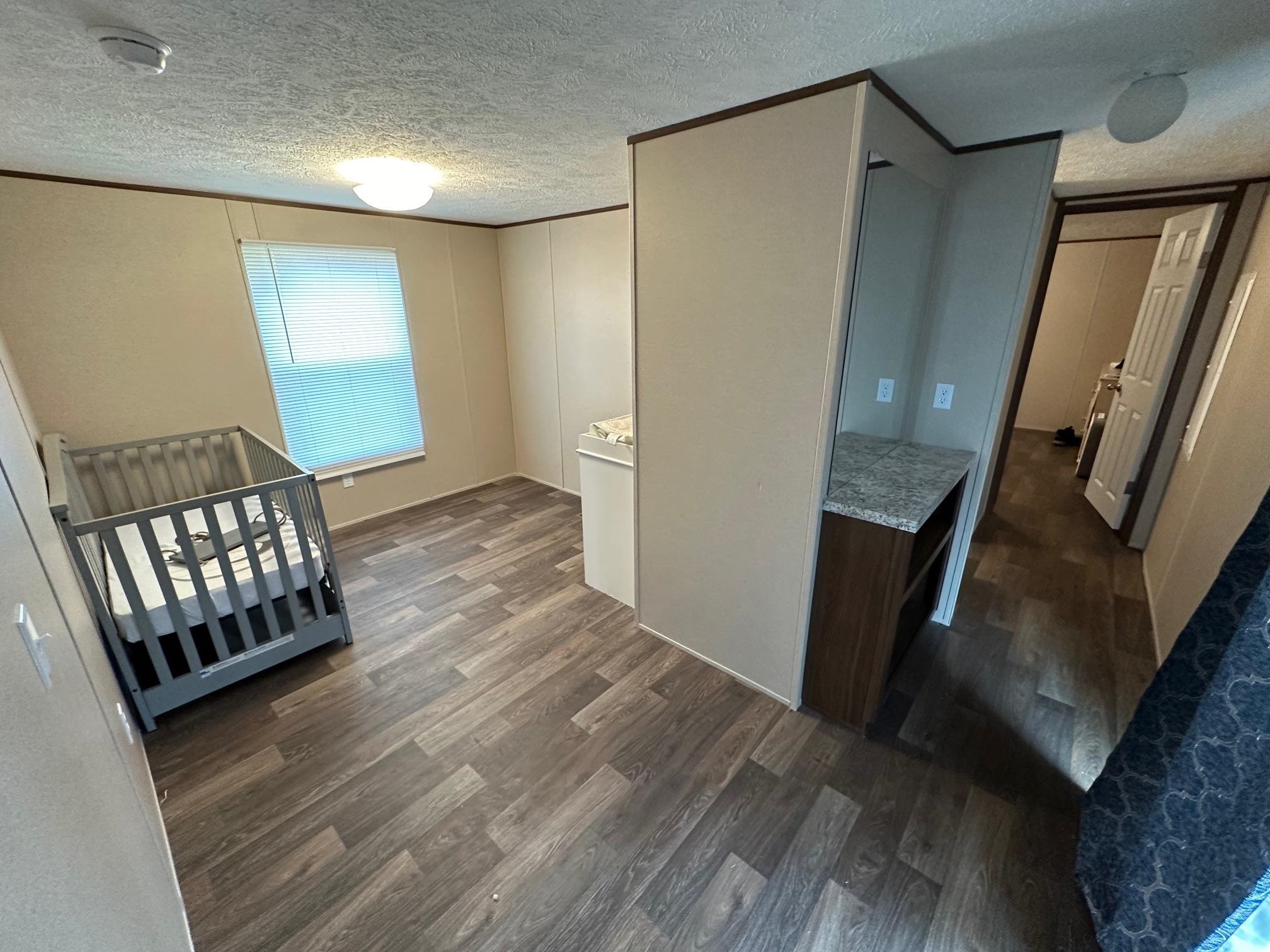 1696 Hardin Graveyard Road Adamsville, TN 38310 - Photo 6 of 25 a view of wooden floor in an empty room