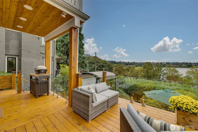 a view of a patio with couches near an ocean