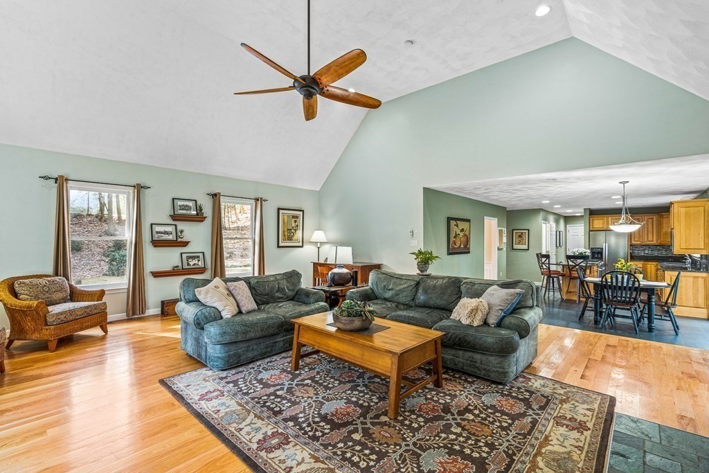 18 Ravens Bluff Andover, MA 01810 - Photo 11 of 41 a living room with furniture a rug and a chandelier