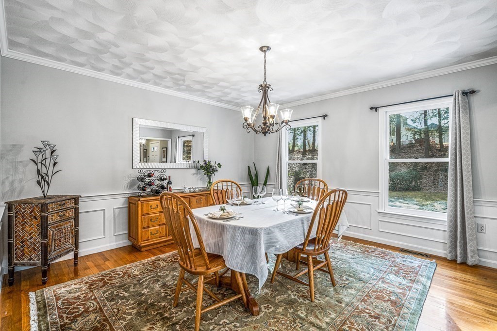 18 Ravens Bluff Andover, MA 01810 - Photo 13 of 41 a dining room with furniture a chandelier and wooden floor