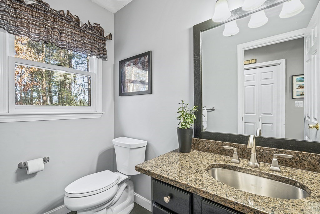 18 Ravens Bluff Andover, MA 01810 - Photo 18 of 41 a bathroom with a granite countertop sink a large mirror and a toilet