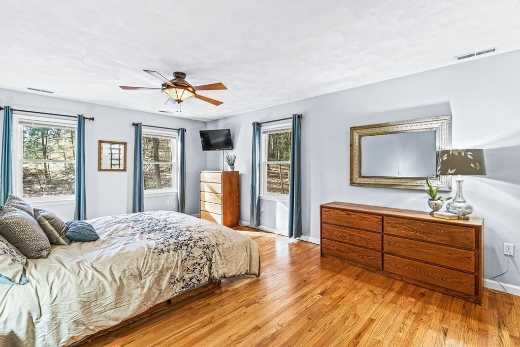18 Ravens Bluff Andover, MA 01810 - Photo 20 of 41 a bedroom with a bed and dresser with mirror