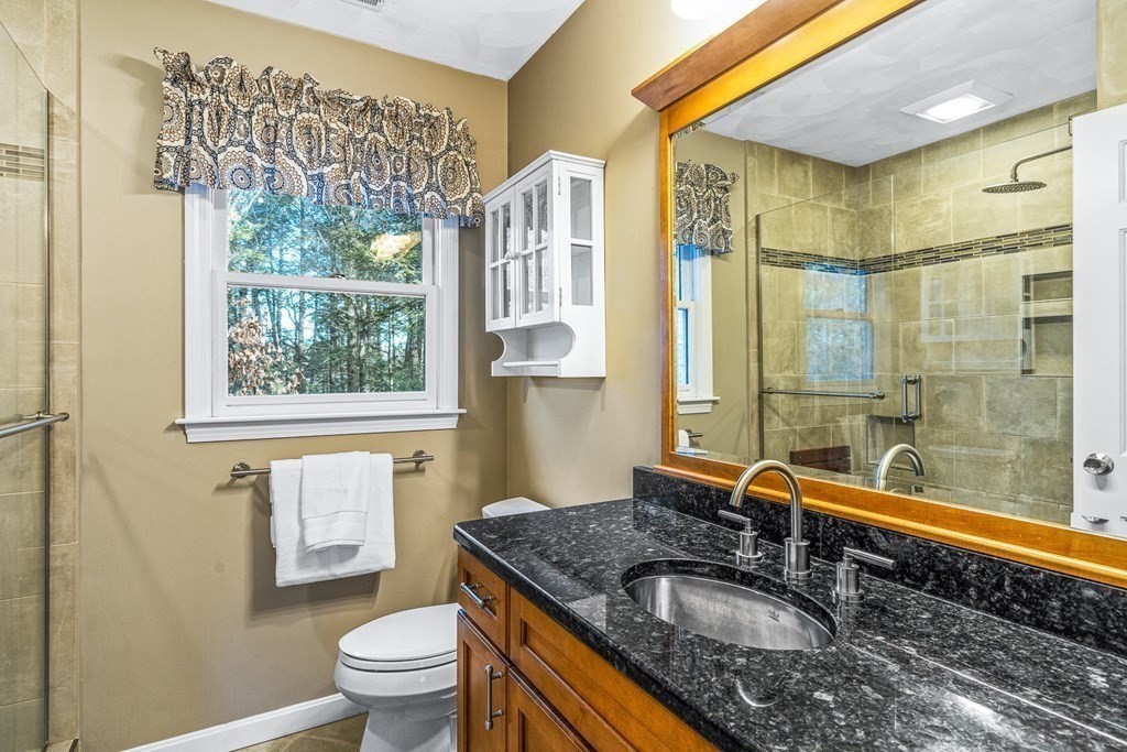 18 Ravens Bluff Andover, MA 01810 - Photo 22 of 41 a bathroom with a granite countertop sink a toilet and shower