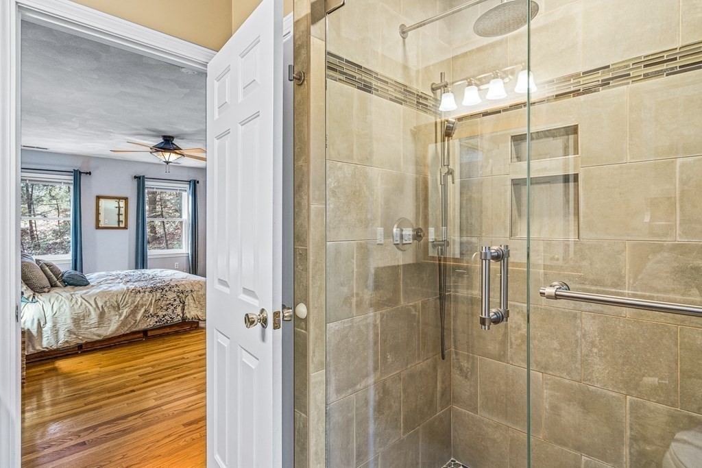 18 Ravens Bluff Andover, MA 01810 - Photo 23 of 41 a bathroom with a granite countertop shower a mirror and a sink