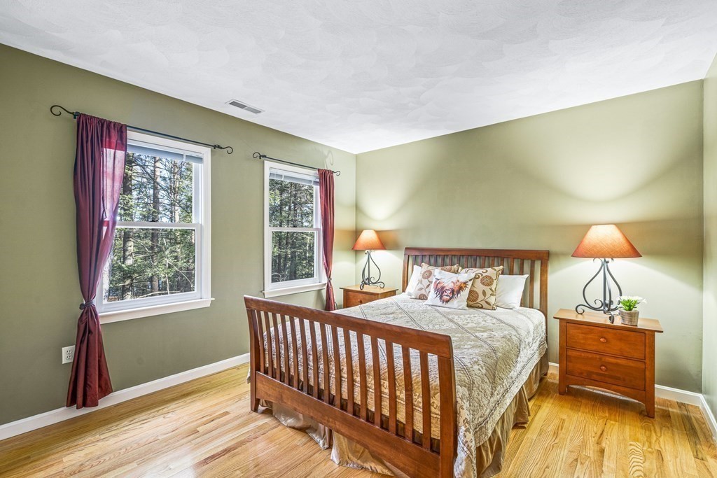 18 Ravens Bluff Andover, MA 01810 - Photo 25 of 41 a bedroom with a bed and a lamp with window