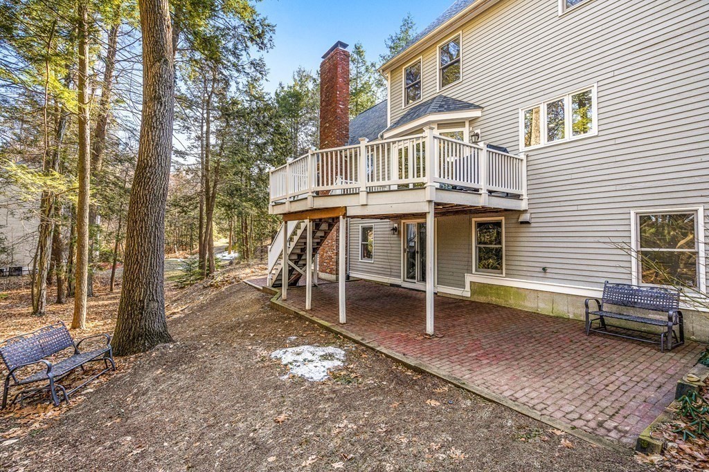 18 Ravens Bluff Andover, MA 01810 - Photo 37 of 41 a white building with a bench and trees