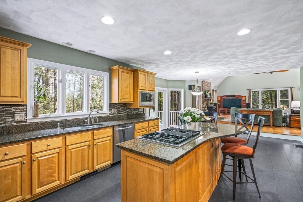 18 Ravens Bluff Andover, MA 01810 - Photo 5 of 41 a kitchen with granite countertop a sink stove and cabinets