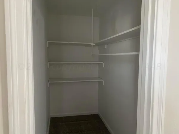 a view of an empty walk in closet