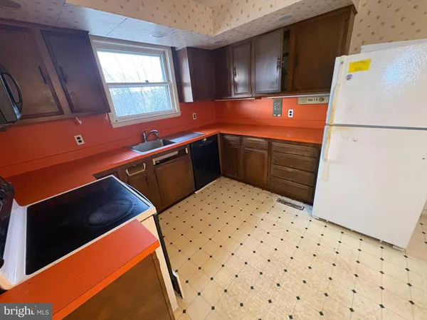 a kitchen with a refrigerator and cabinets