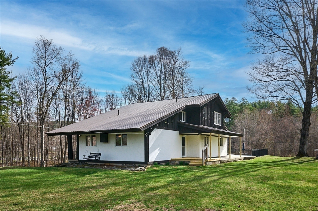 14 East Hawley Road Charlemont, MA 01339 - Photo 36 of 42 a view of a house with a big yard and large trees