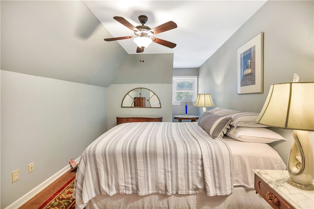 910 Chantilly Lane Anderson, SC 29625 - Photo 17 of 38 Sloped ceilings and a warm wooden floor create a cozy retreat in this bedroom.