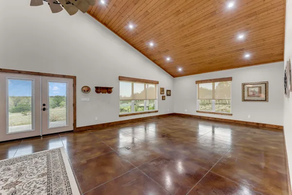 a view of a livingroom with wooden floor and window