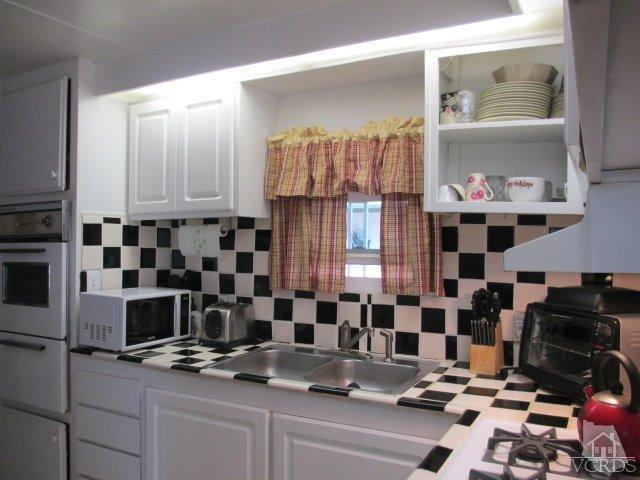 1225 South Rice Road, Unit 5 Ojai, CA 93023 - Photo 11 of 41 a kitchen with a sink and a stove top oven