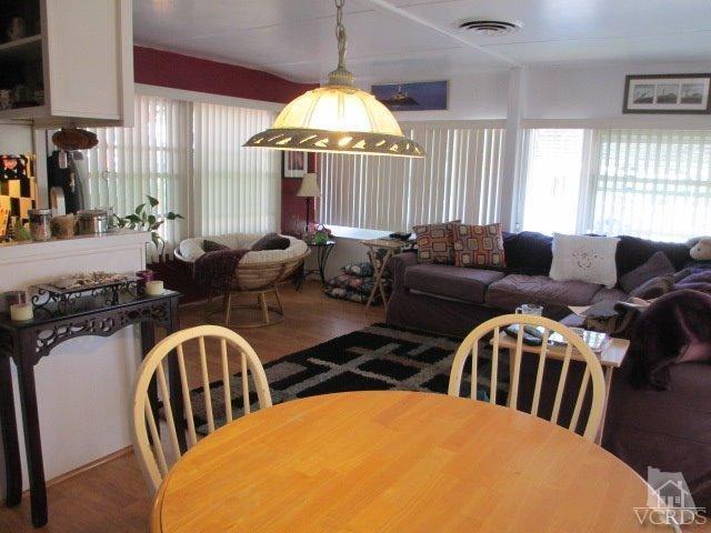 1225 South Rice Road, Unit 5 Ojai, CA 93023 - Photo 18 of 41 a living room with furniture a chandelier and a large window
