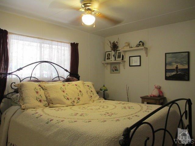 1225 South Rice Road, Unit 5 Ojai, CA 93023 - Photo 19 of 41 a bedroom with a bed and a dresser