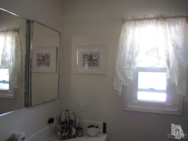 1225 South Rice Road, Unit 5 Ojai, CA 93023 - Photo 23 of 41 a bathroom with a window and a mirror