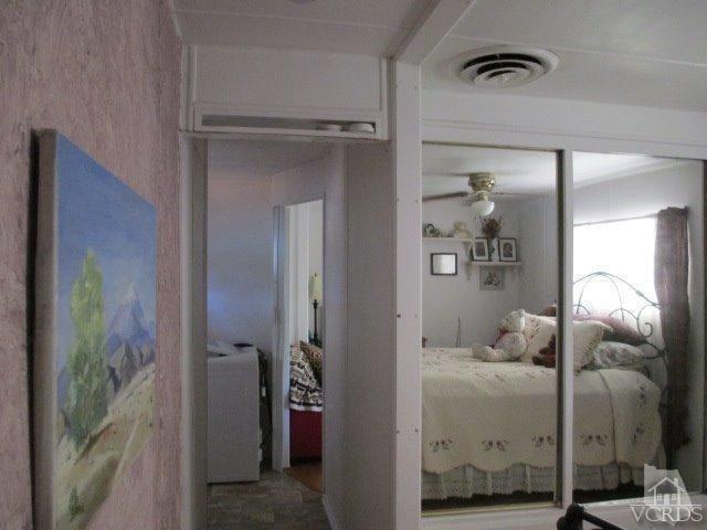 1225 South Rice Road, Unit 5 Ojai, CA 93023 - Photo 24 of 41 a bedroom with a bed and a mirror