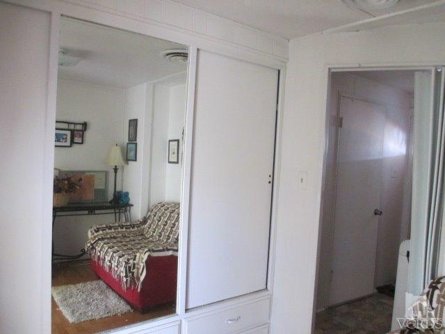1225 South Rice Road, Unit 5 Ojai, CA 93023 - Photo 27 of 41 a bedroom with a bed and a mirror
