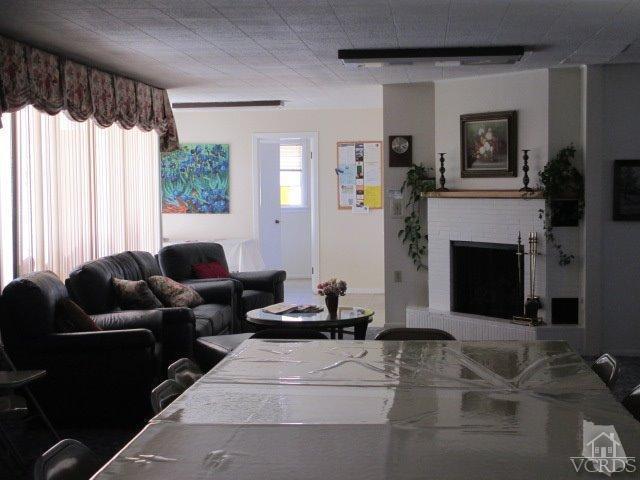 1225 South Rice Road, Unit 5 Ojai, CA 93023 - Photo 39 of 41 a living room with furniture windows and a fireplace