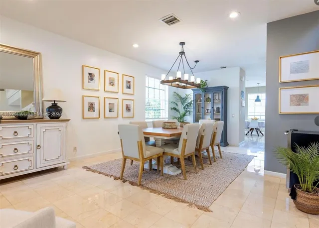 a dining room with furniture and chandelier