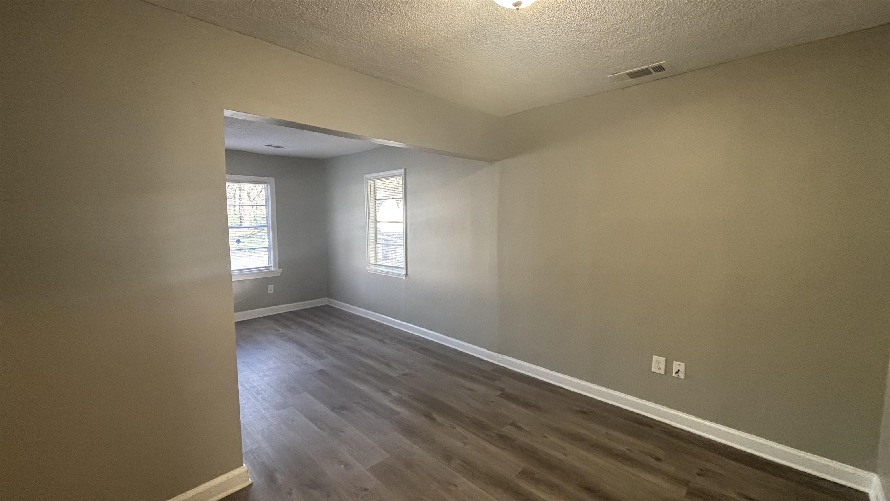 3133 Benjestown Road Memphis, TN 38127 - Photo 8 of 17 an empty room with wooden floor and windows