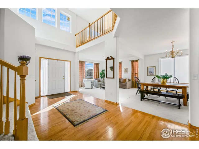 a living room with furniture kitchen view and a chandelier