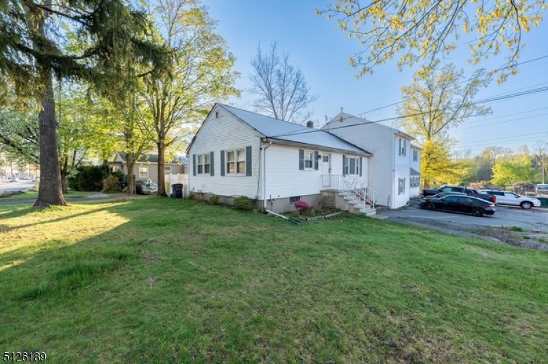 47 River Road Chatham, NJ 07928 - Photo 2 of 21 a front view of house with yard and green space