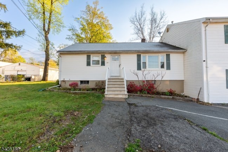 47 River Road Chatham, NJ 07928 - Photo 21 of 21 a view of a house with a small yard and large tree