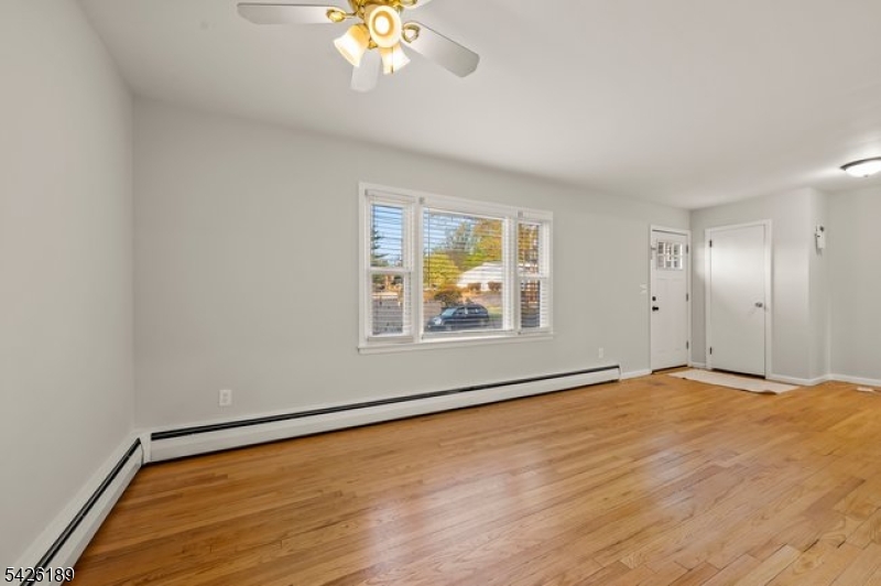 47 River Road Chatham, NJ 07928 - Photo 3 of 21 a view of an empty room with a window and wooden floor