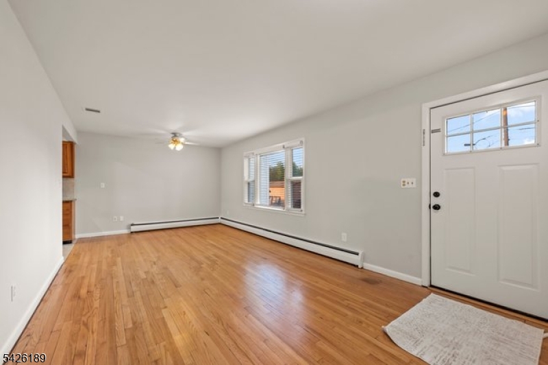 47 River Road Chatham, NJ 07928 - Photo 4 of 21 a view of an empty room with wooden floor and a window