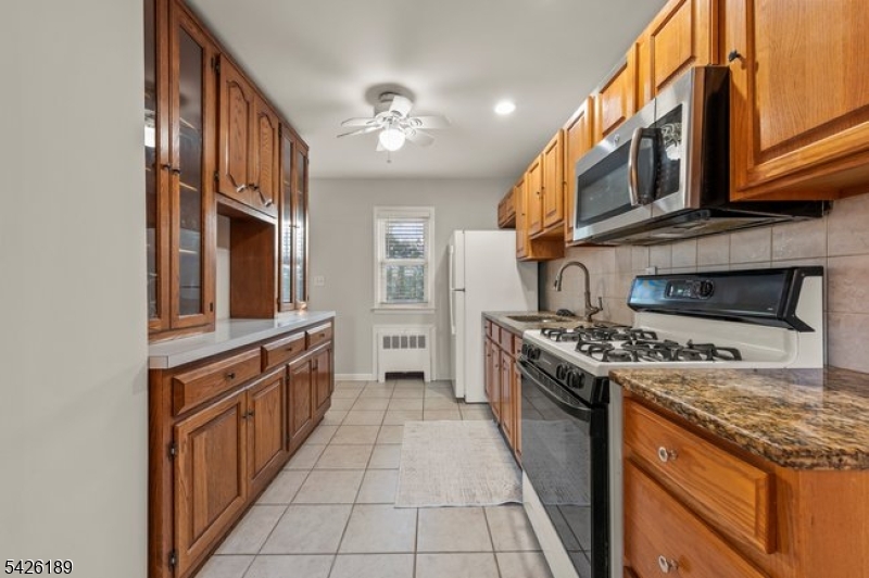 47 River Road Chatham, NJ 07928 - Photo 6 of 21 a kitchen with stainless steel appliances granite countertop a stove and a sink