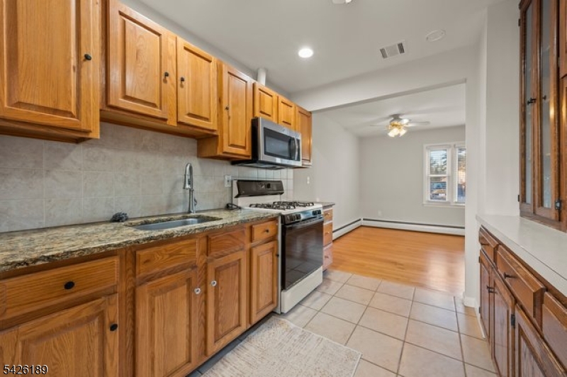 47 River Road Chatham, NJ 07928 - Photo 7 of 21 a large kitchen with stainless steel appliances granite countertop a sink and cabinets