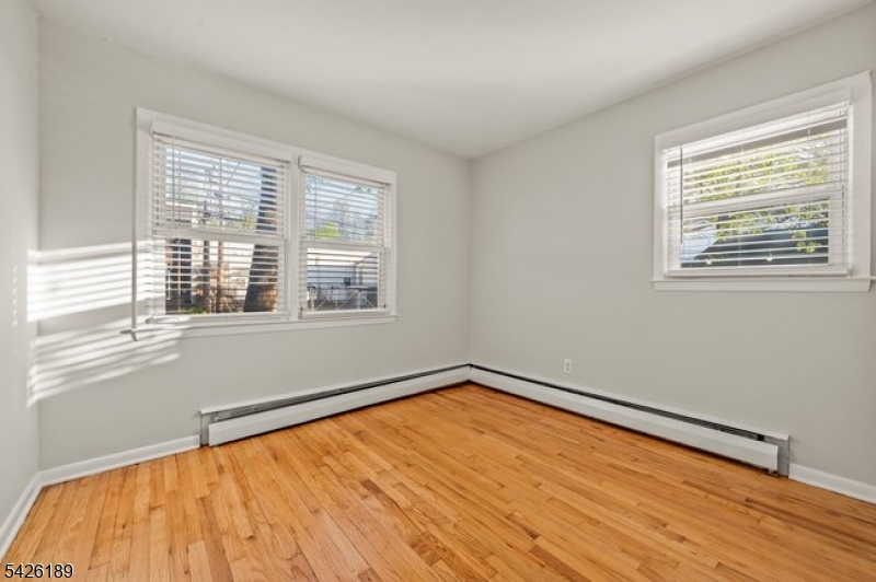 47 River Road Chatham, NJ 07928 - Photo 8 of 21 a view of an empty room with wooden floor and a window