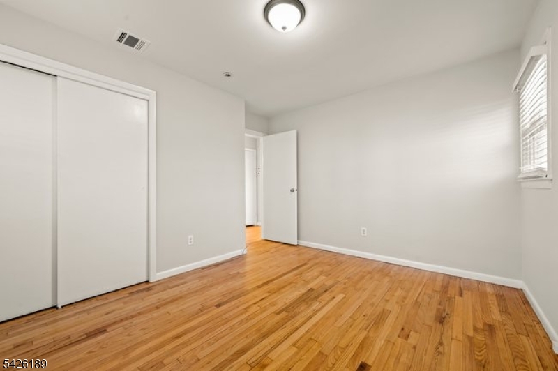 47 River Road Chatham, NJ 07928 - Photo 9 of 21 a view of an empty room with wooden floor